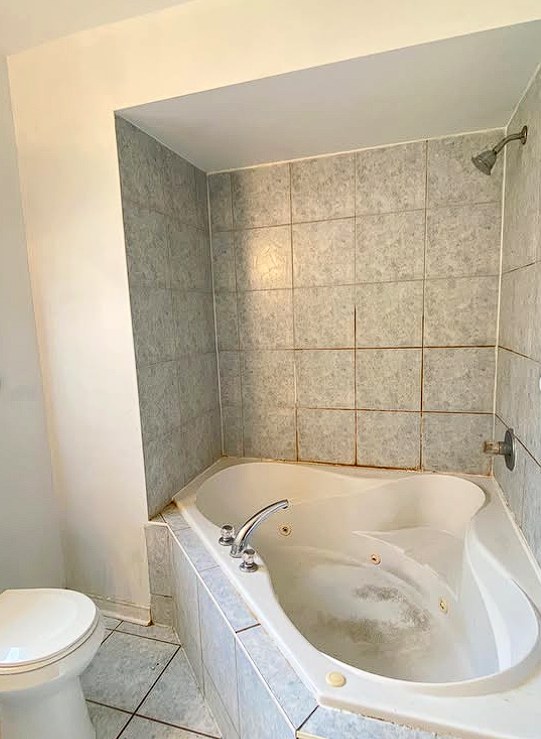 Original bathroom with builder-grade tile before renovation