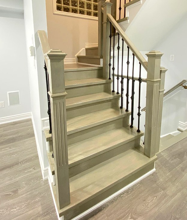 Finished hardwood staircase with iron balusters and oak handrail