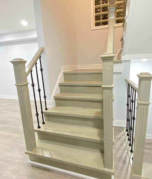 Detail of fluted newel posts and hardwood treads